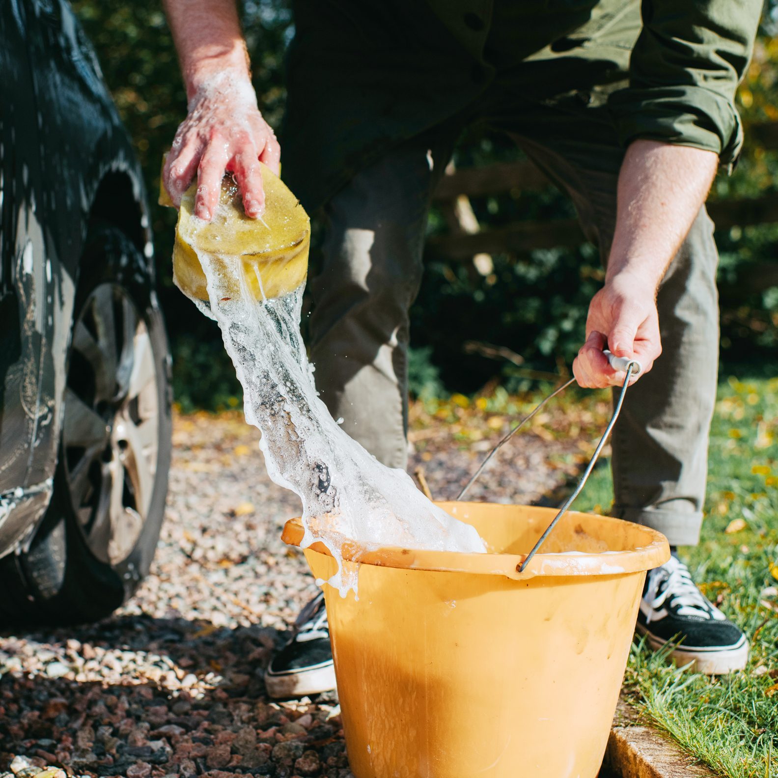 washing car with a bucket and a sponge