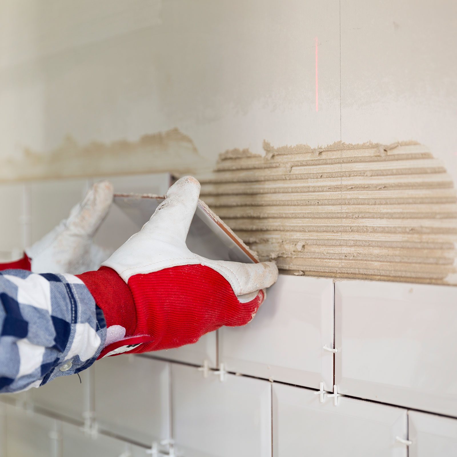 Process Of Tiling The Tiles In The Kitchen With the necessary tools