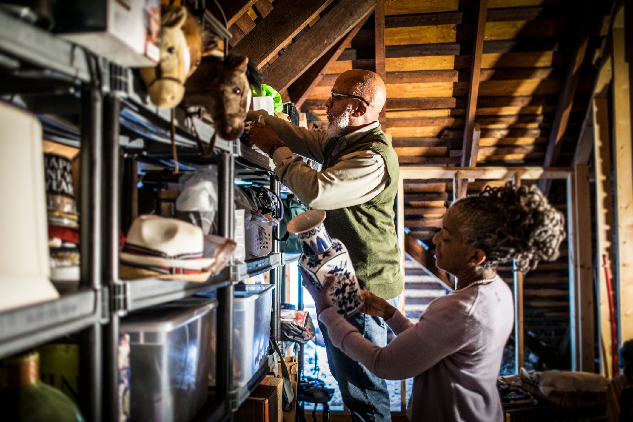 Senior couple organizing items in home attic