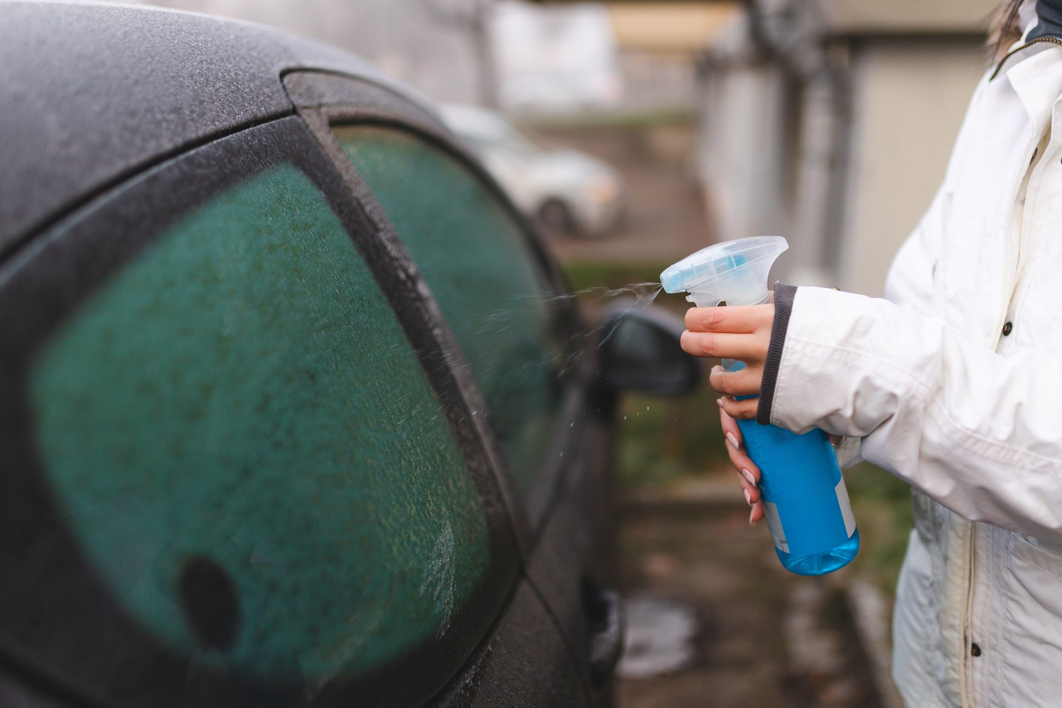 Close-up of a defrost spray used on a car window