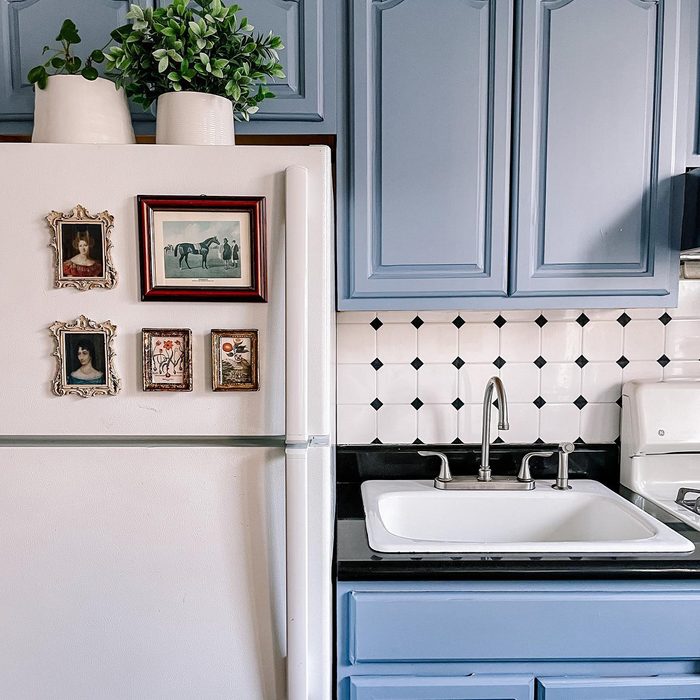 apartment kitchen wit contact blue contact paper covering the cabinets