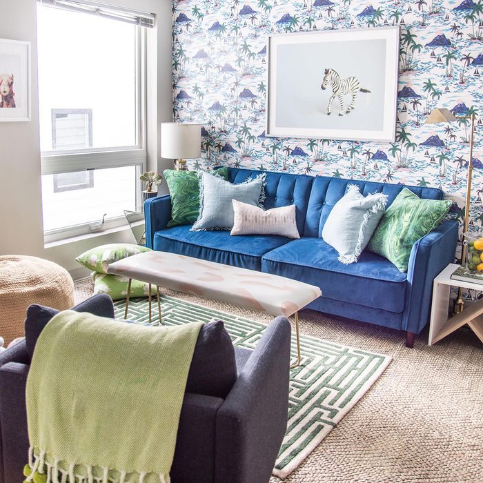 apartment living room with blue couch and removable wallpaper