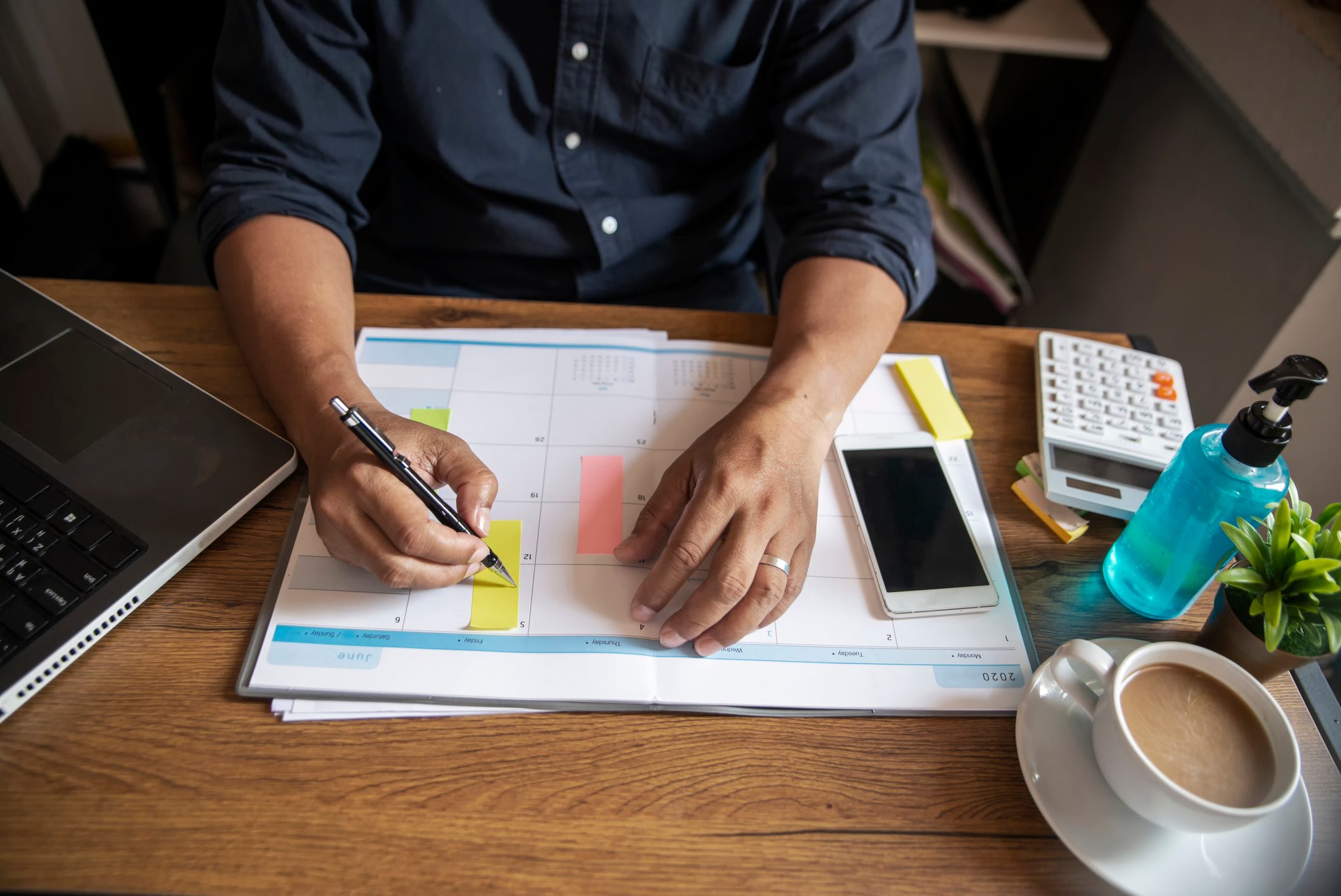 Male hand of planner writing daily appointment