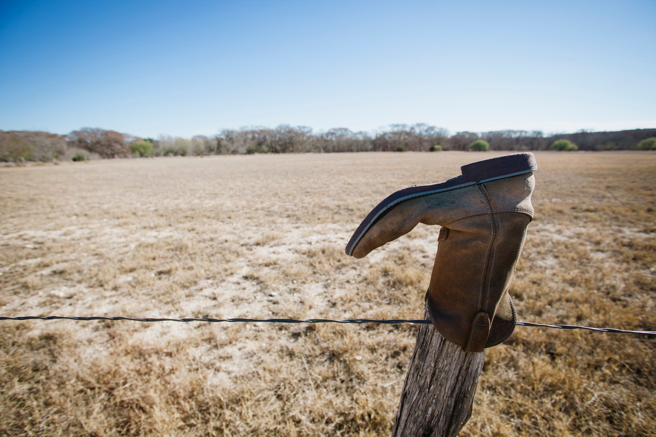 Abandoned boot on fencepost