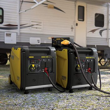 Two inverter generators side by side on concrete