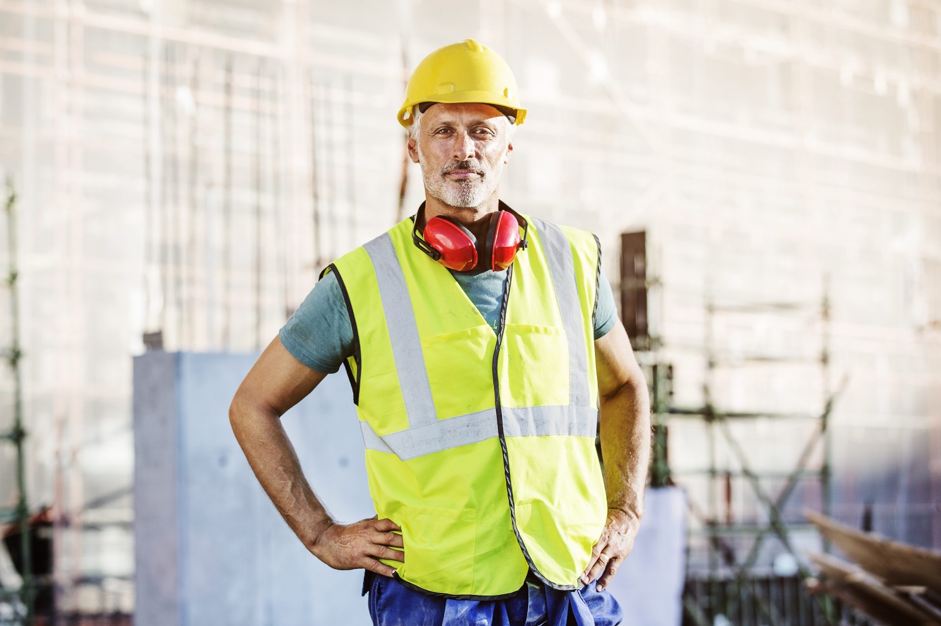 Confident architect standing at construction site