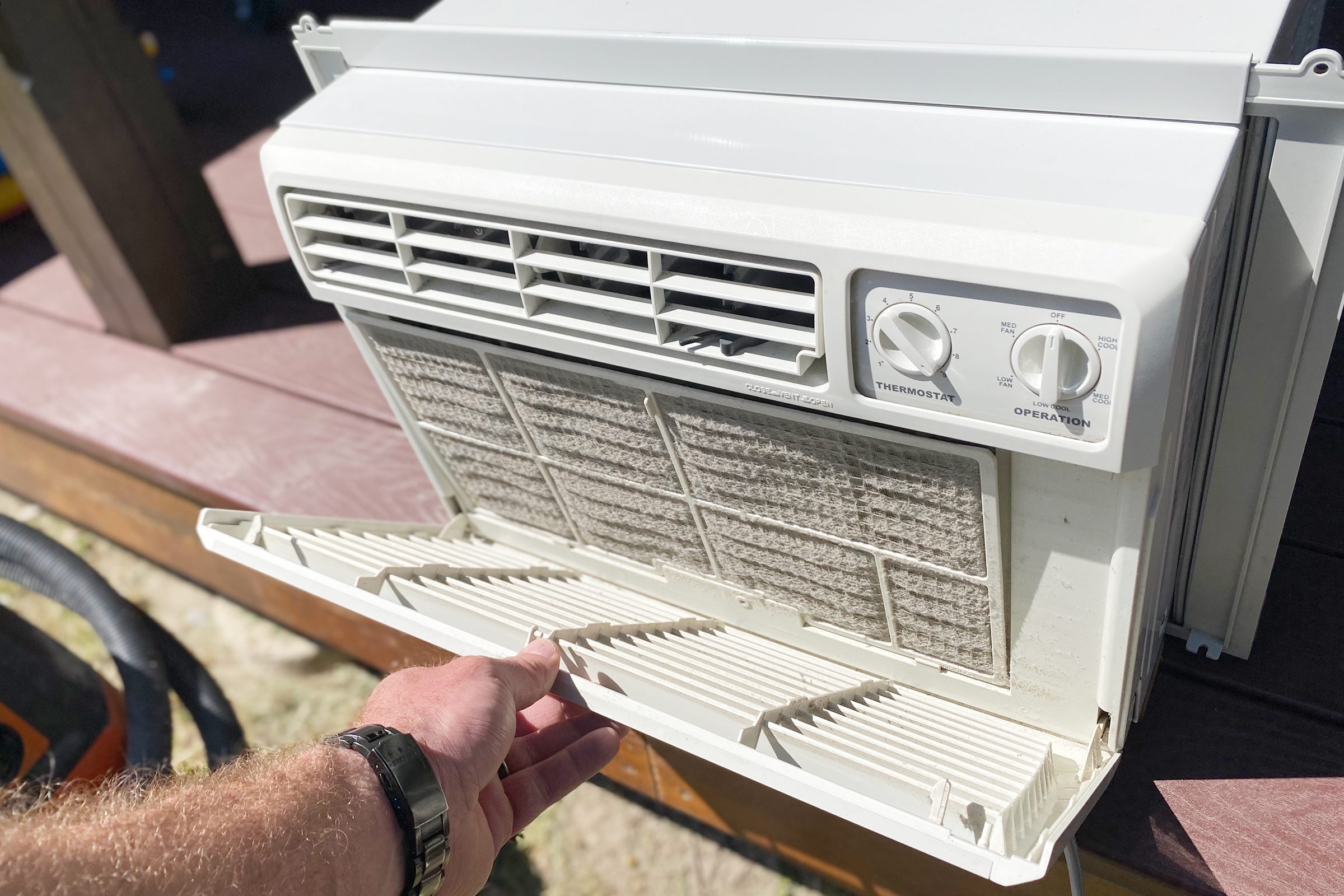 open air conditioner cover to remove filter