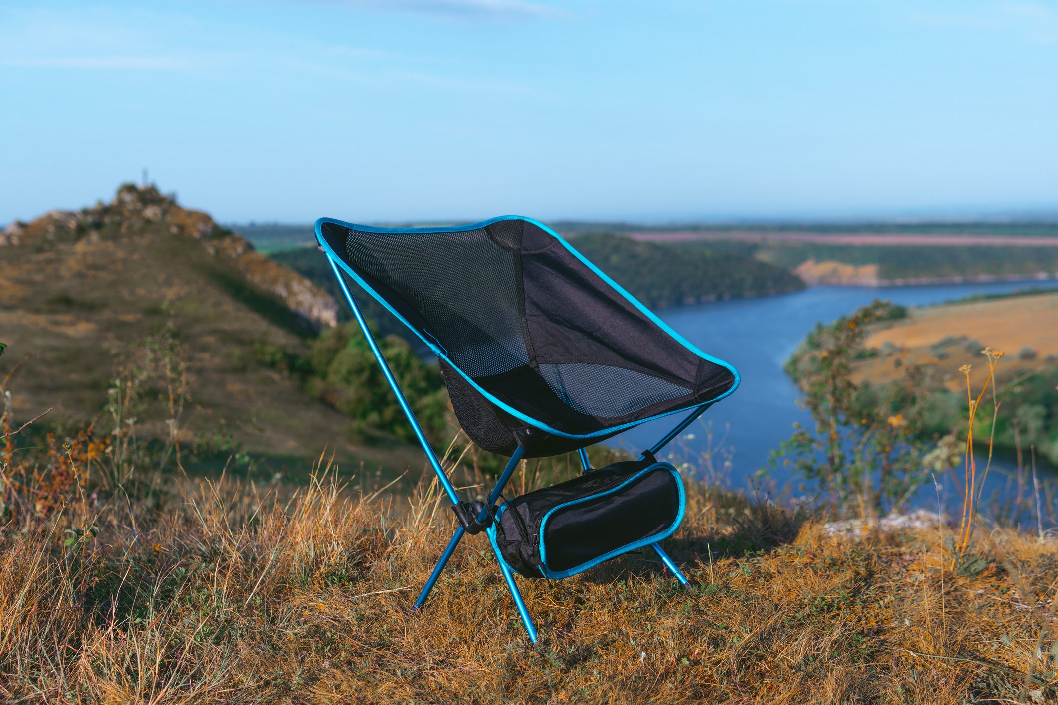 lightweight and compact equipment. Folding chair stand on top of the mountain. Tourism equipment in nature in a natural environment. Equipped holiday camp. no bodies.