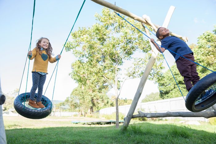 Children playing on tire swings