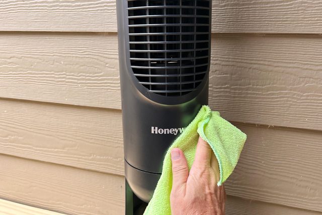 using a Microfiber cloth to clean a fan