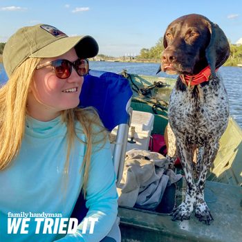 woman and her dog on a boat in the summer wearing SPF clothing