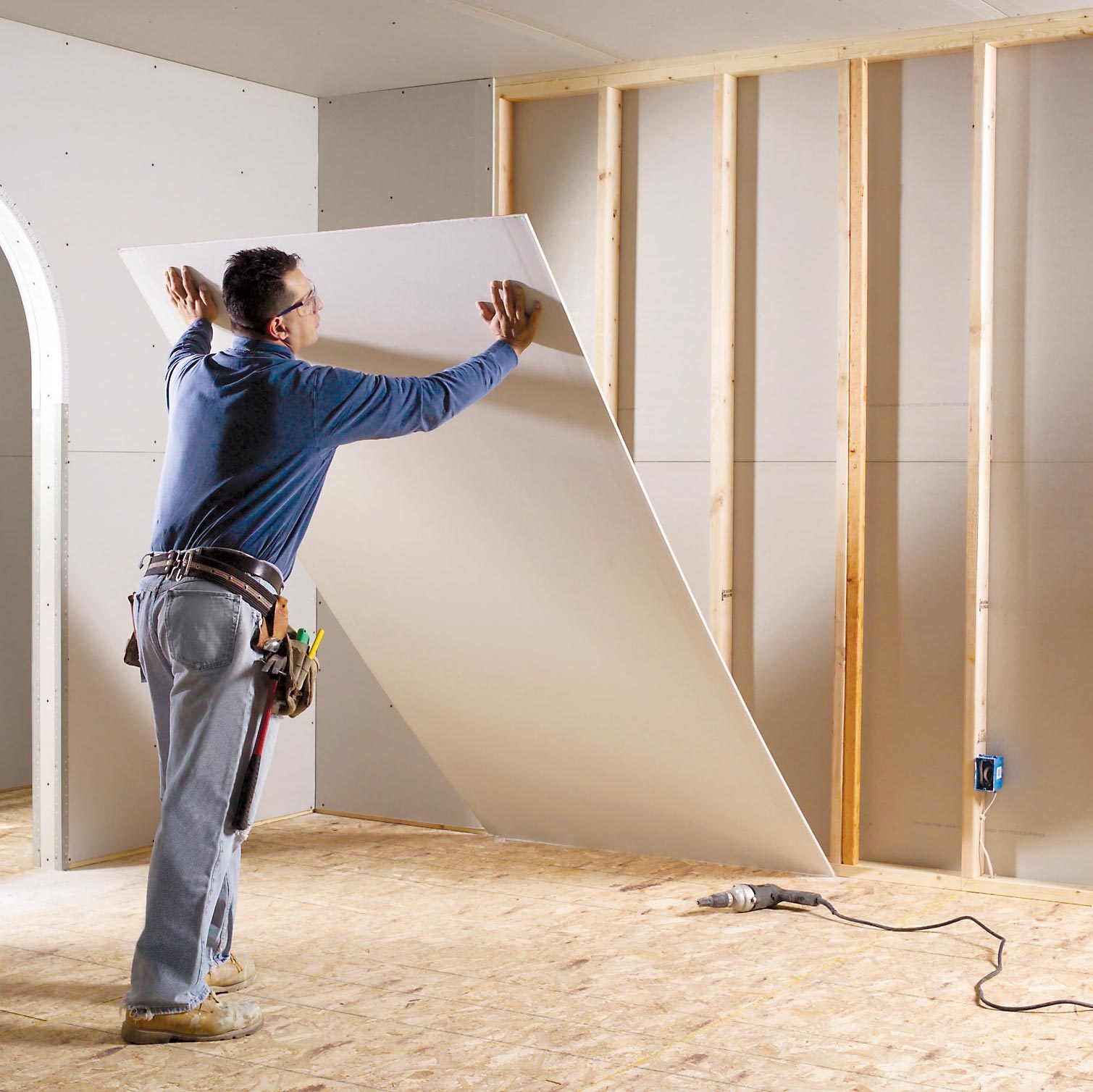 man putting up drywall