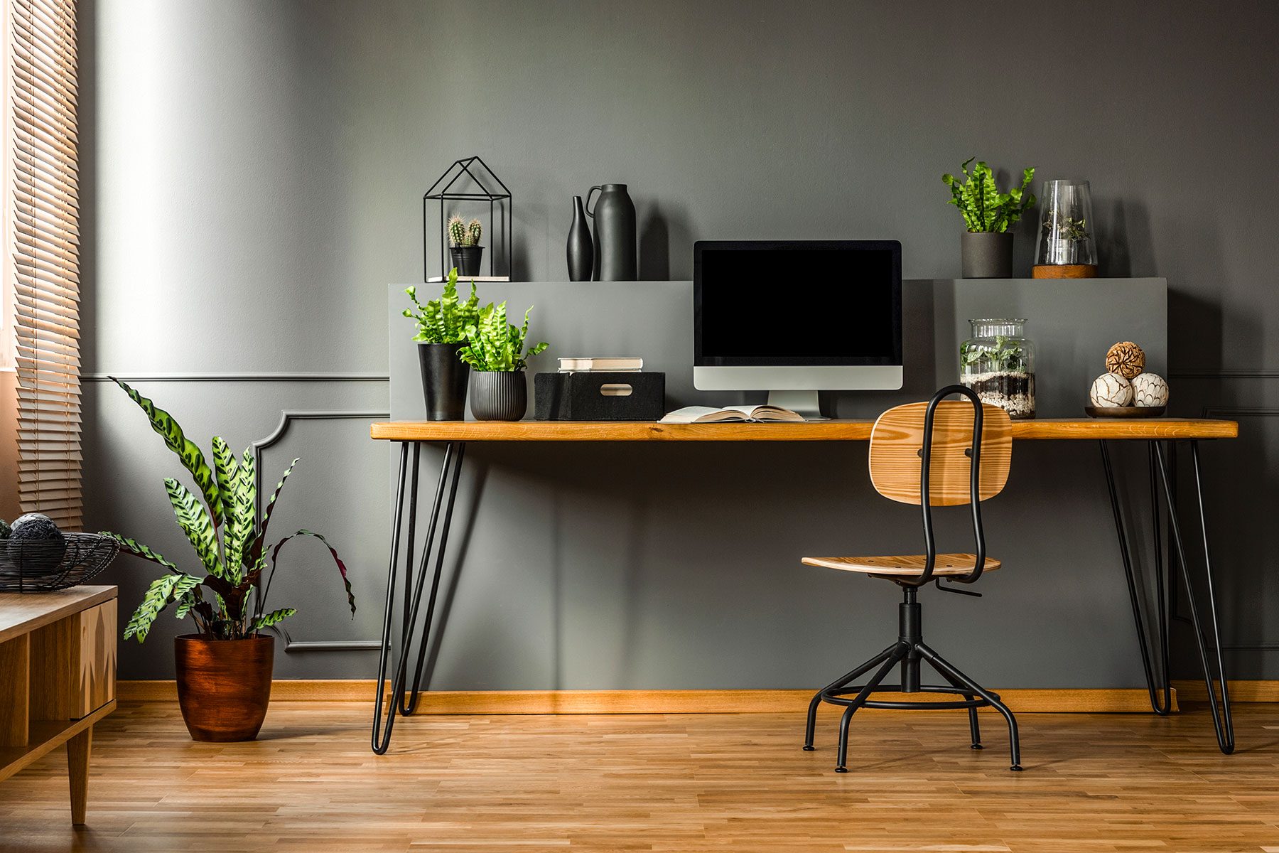 Real Photo Of A Dark Interior With Wooden Desk, Chair And Computer In The Study Space In The Middle