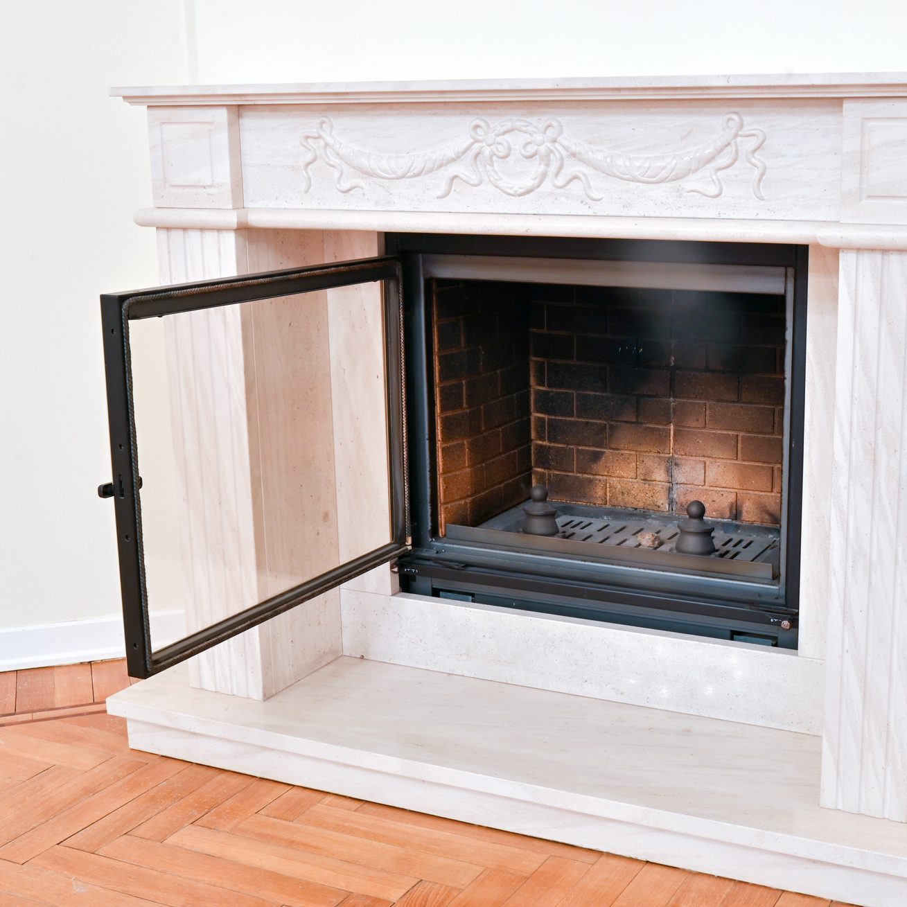 Stylish modern fireplace with a fireproof glass door in a rich house