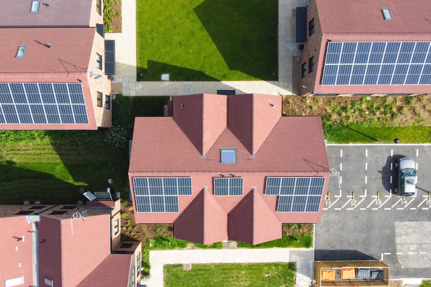 Overhead aerial view of a modern housing development with solar panels installed on the rooftops for sustainable electricity