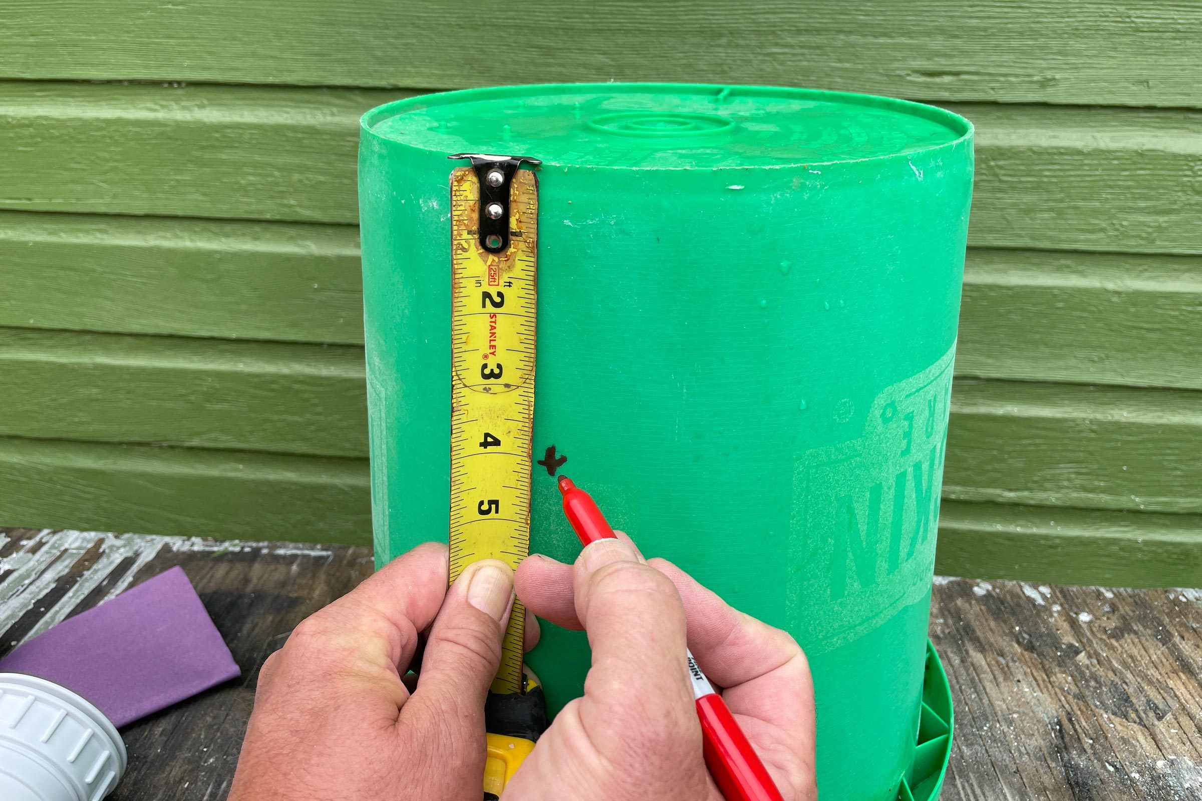 marking holes on a bucket