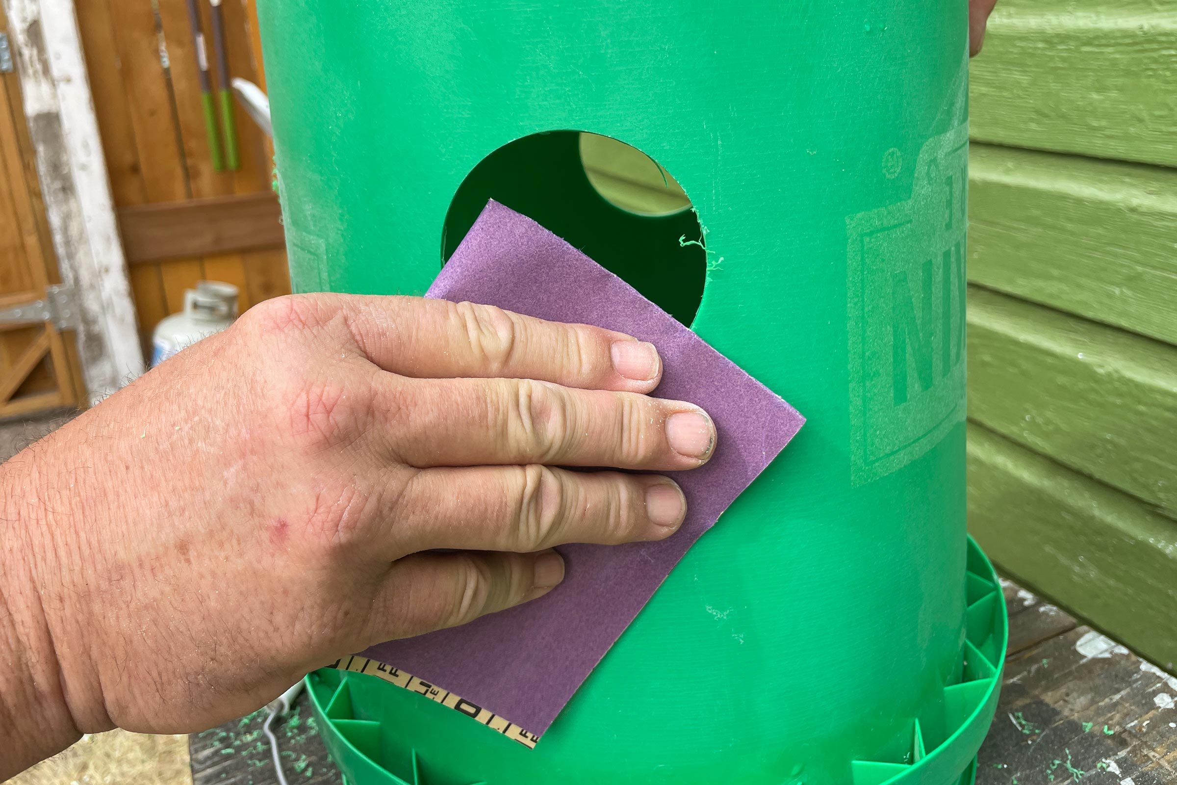 sanding holes drilled in a bucket