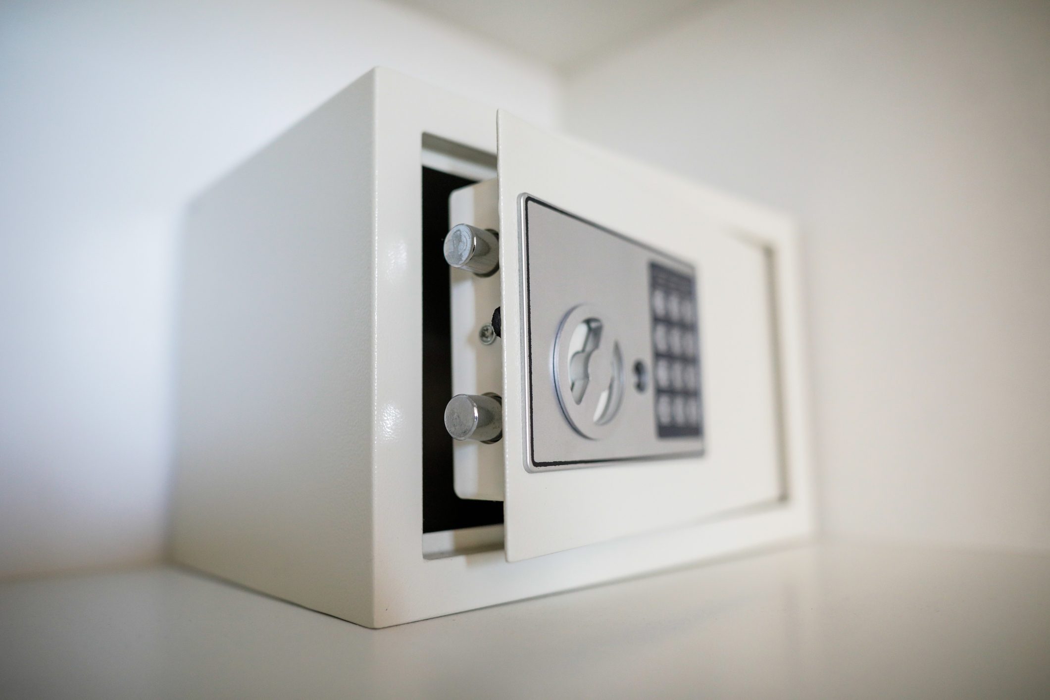 white Metal safe in a home. safe door is ajar