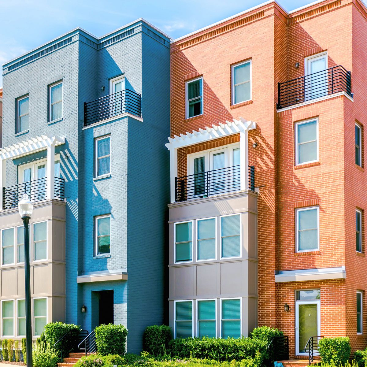 Row of brick townhouses on residential street in Alexandria, Virginia