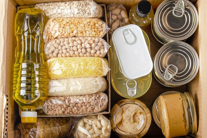 Flat Lay View At Uncooked Foods In Carton Box Prepared For Disaster Emergency Conditions