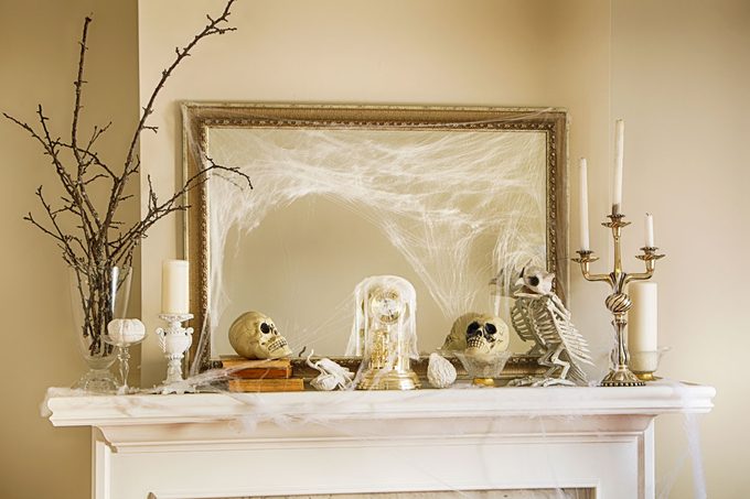 Fireplace Halloween Decorations with assorted skulls, cobwebs and fall decorations