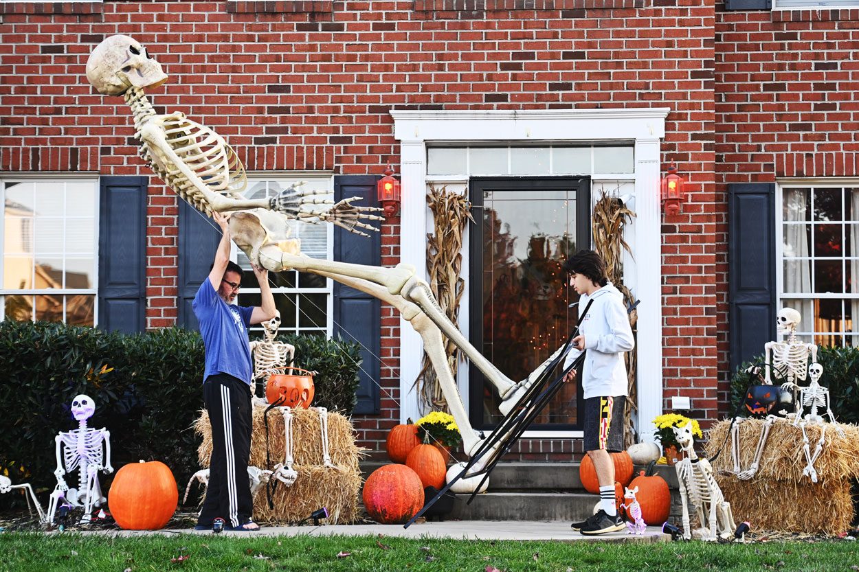 Stephen Ferrone (left) and his son Stevie Ferrone, 16 carry Herman back into their garage in Middletown, Maryland on October 20, 2020.