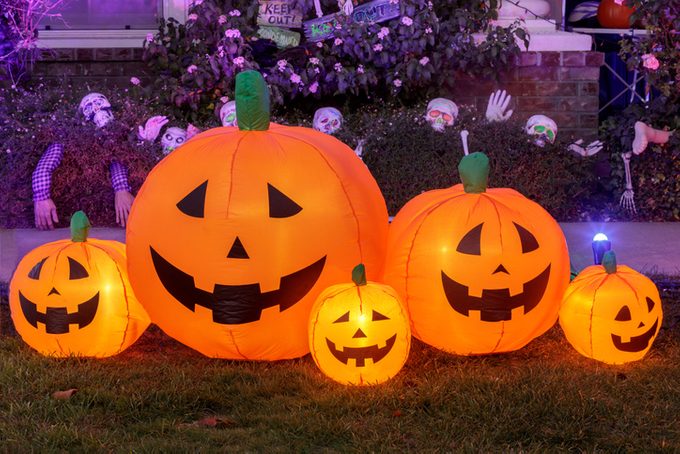 Inflatable pumpkin decorations glowing in the front yard of a house