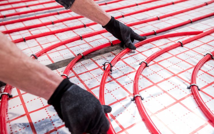 Pipefitter install system of underfloor heating system at home