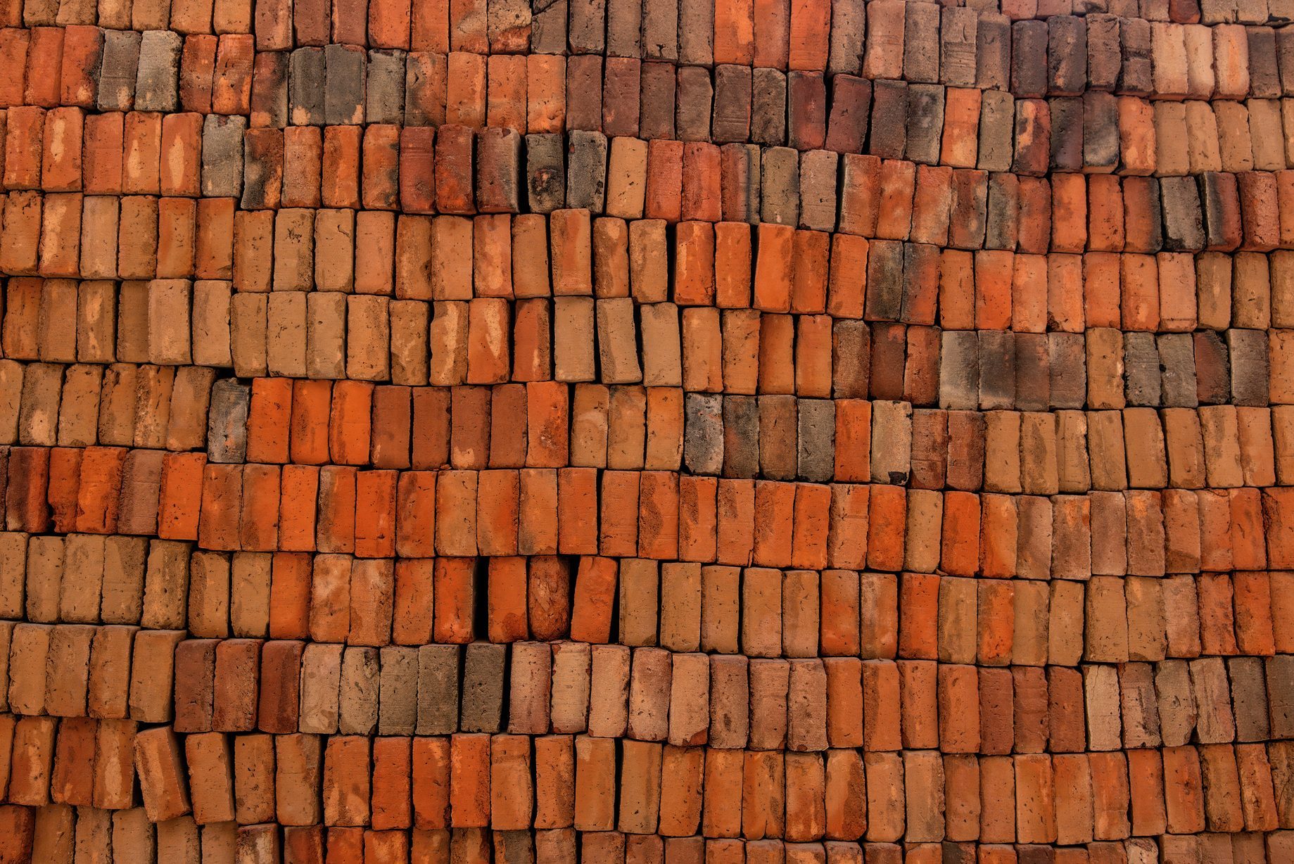 Large stack of orange clay bricks