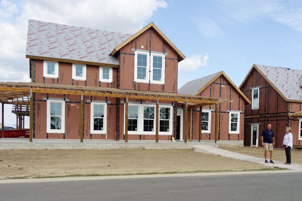 People stand near a home under construction at southwest Floridas Babcock Ranch, which is being built with an engineered wood and Styrofoam material that builders say is more resistant to hurricanes than cinderblock