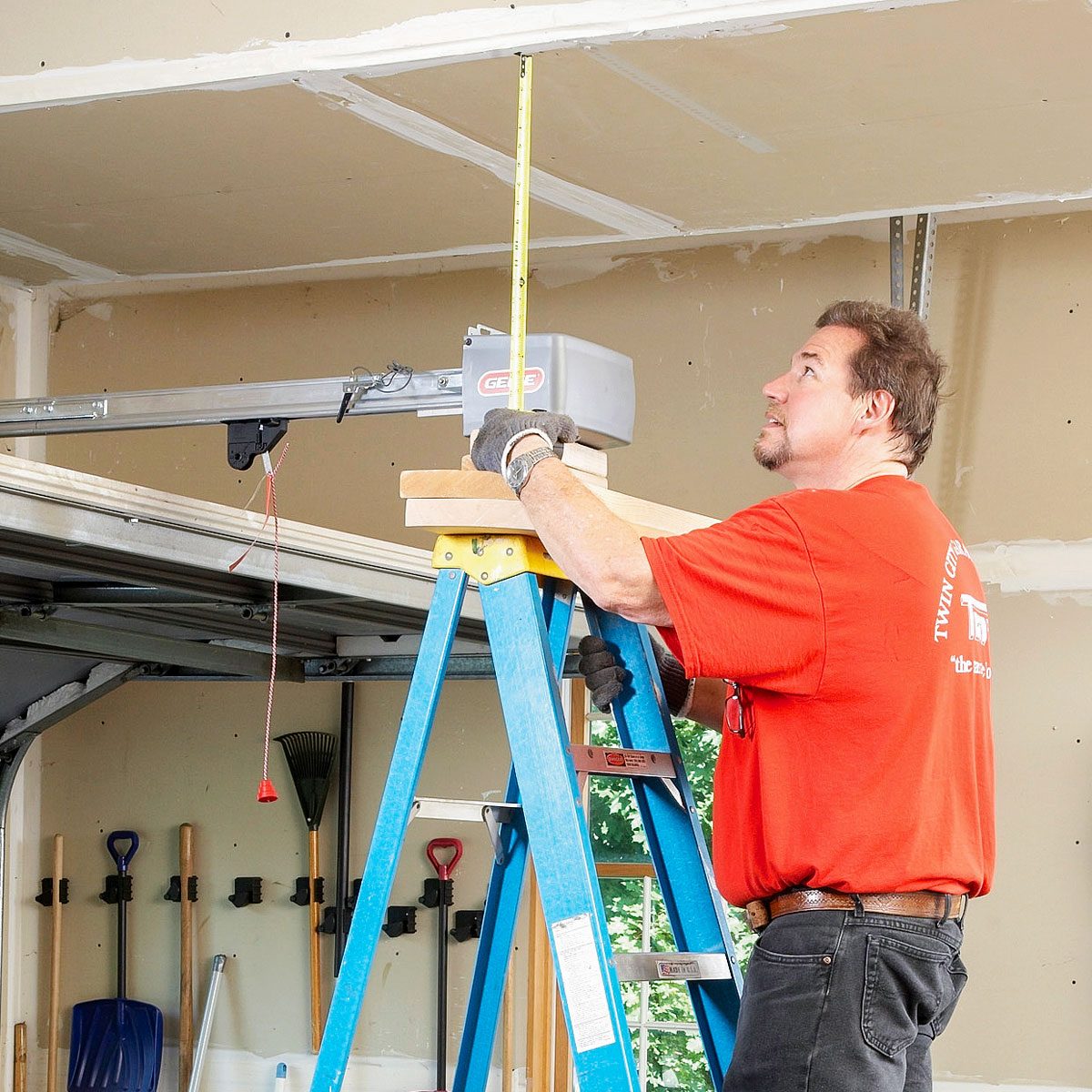 Positioning Garage Door Opener on a Ladder for Installation