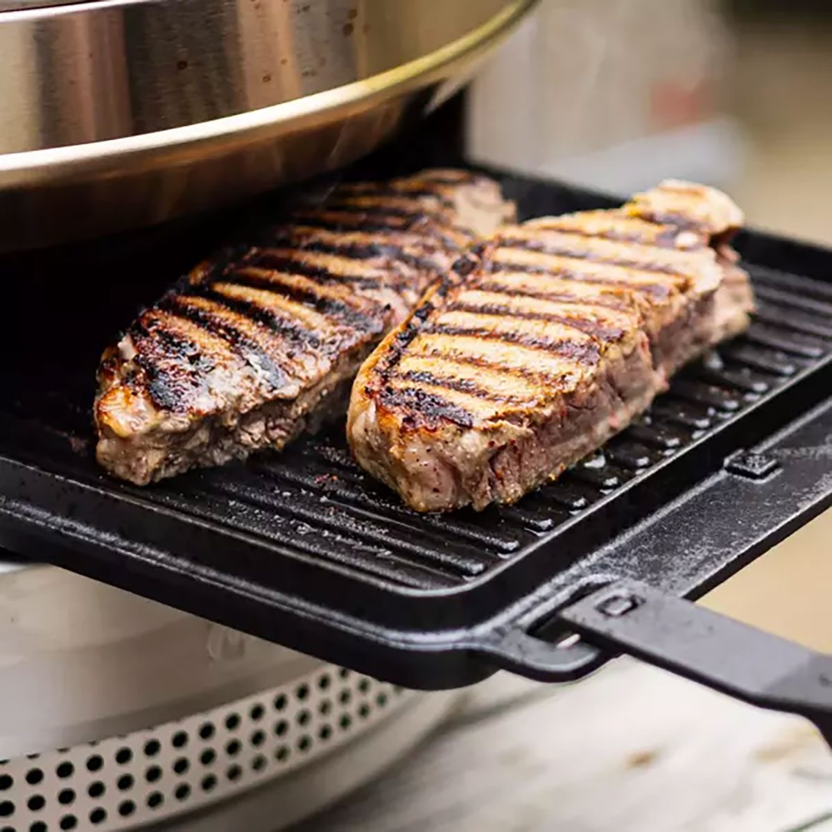 Skillet with grilled meat on it