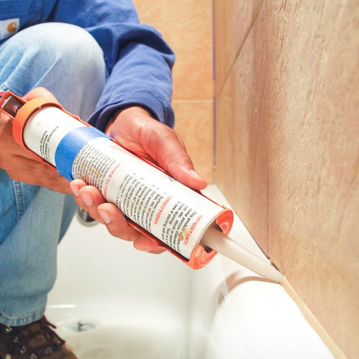 Caulking Bathtub with Caulk Gun