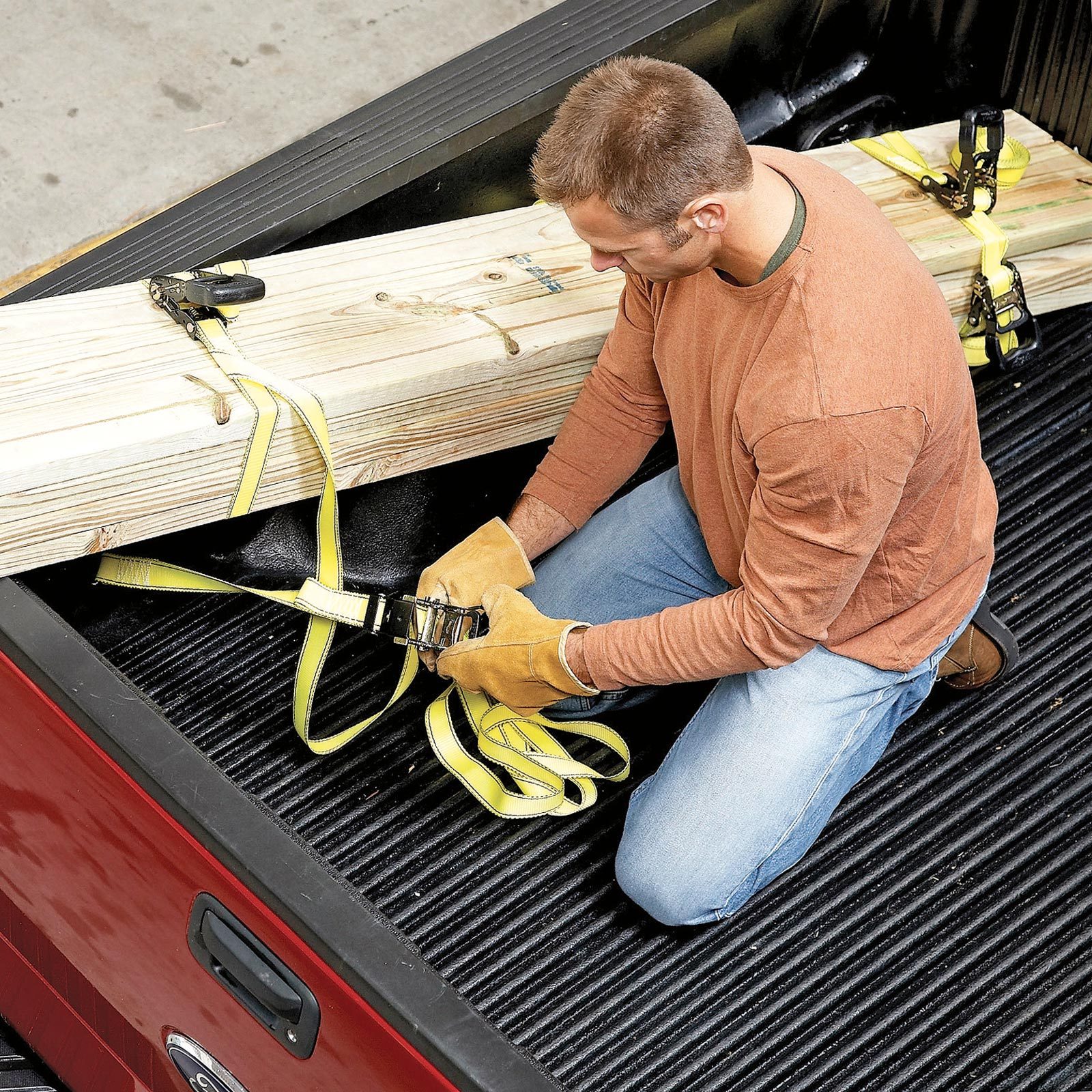 securing wood in back of pick up truck with yellow straps