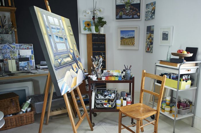 Creative artist studio with painting on easel.
