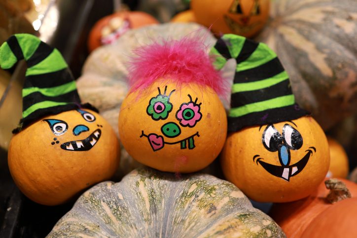 Funny painted grimace on pumpkins for Halloween