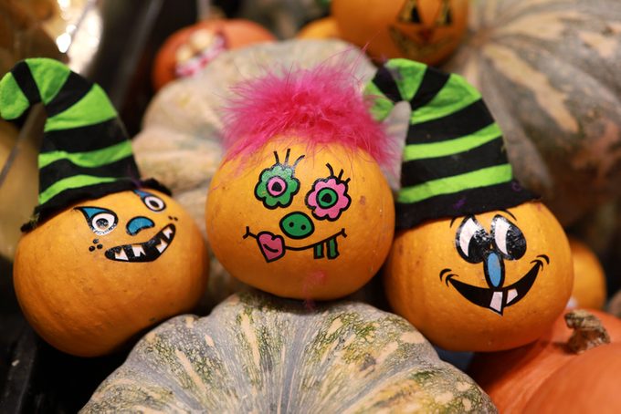 Funny painted grimace on pumpkins for Halloween
