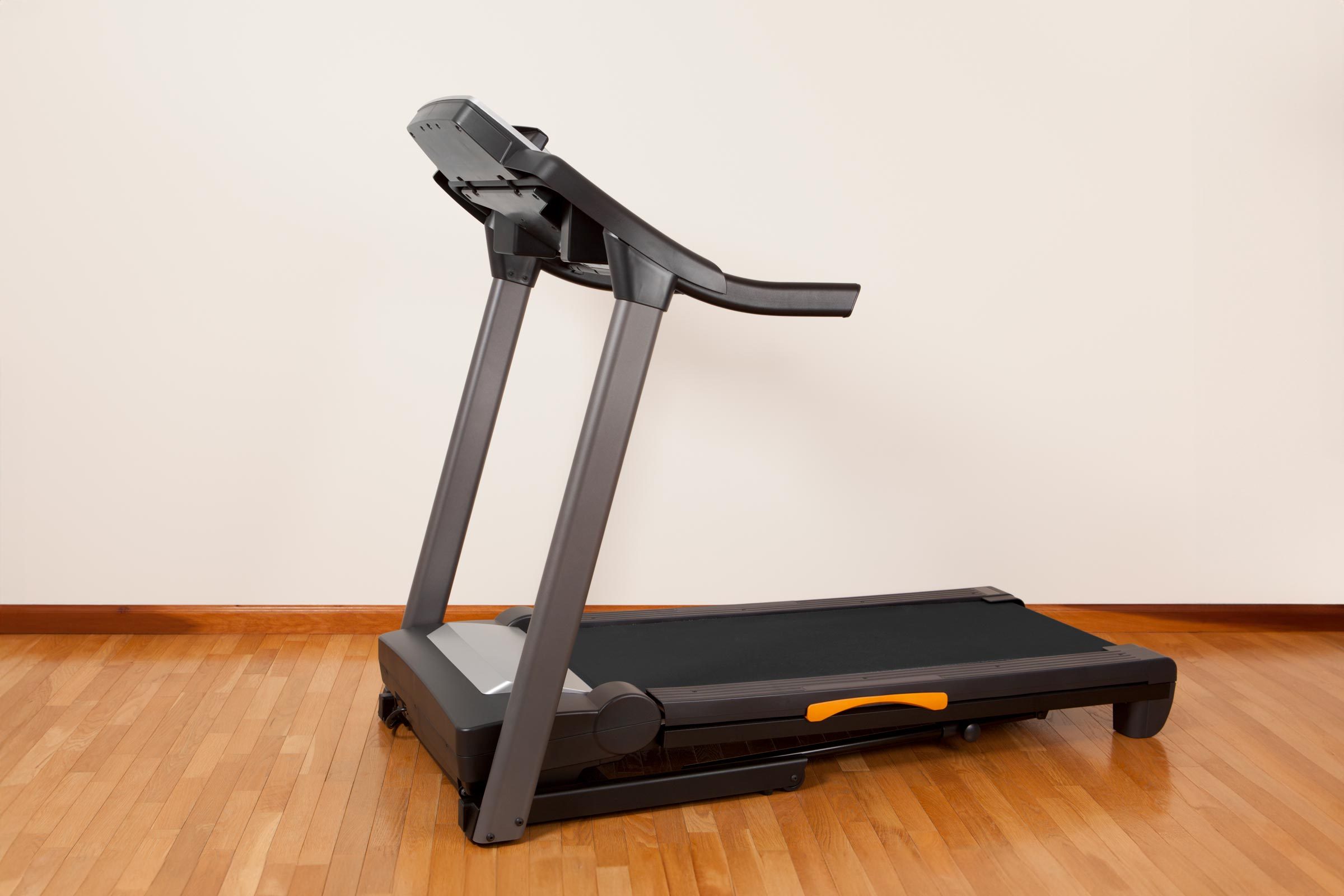 treadmill in room with hardwood floors