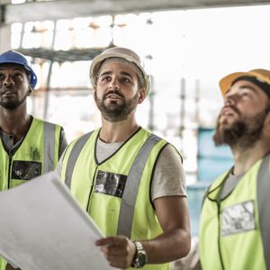 Construction workers discussing building plan