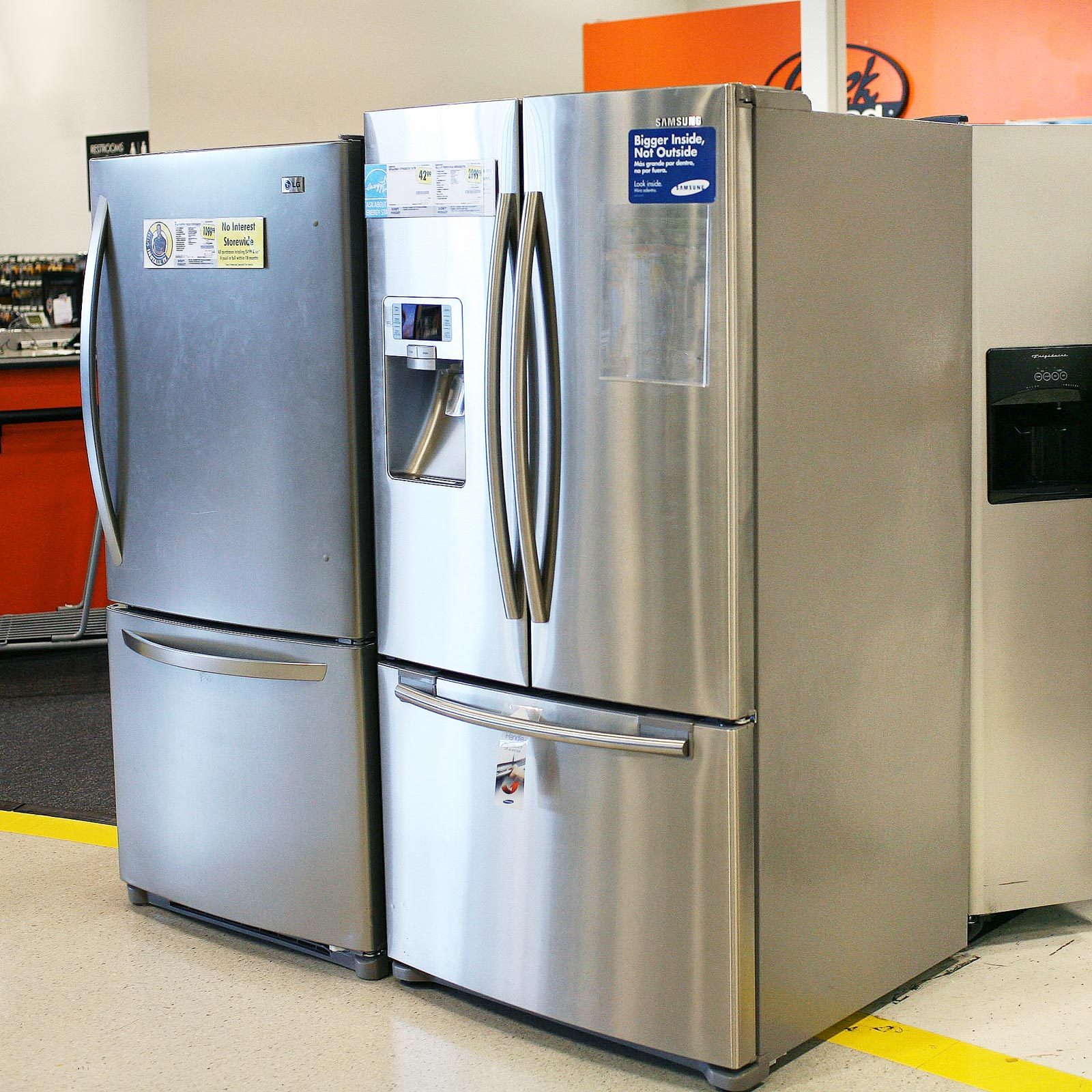 two different sized refrigerators at a store