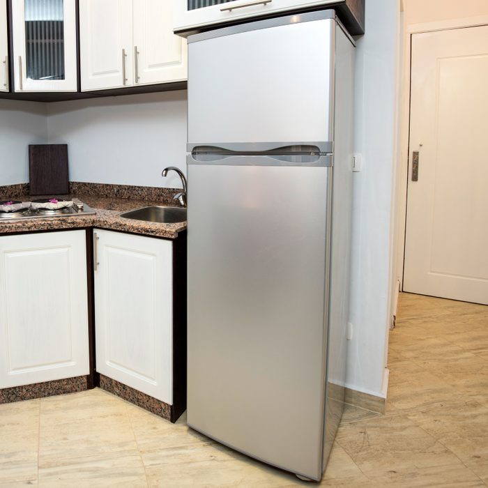 compact fridge in small apartment kitchen