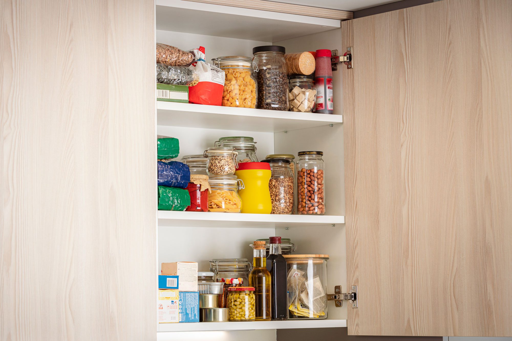 Open Cabinet Full Of Groceries In A Modern Kitchen