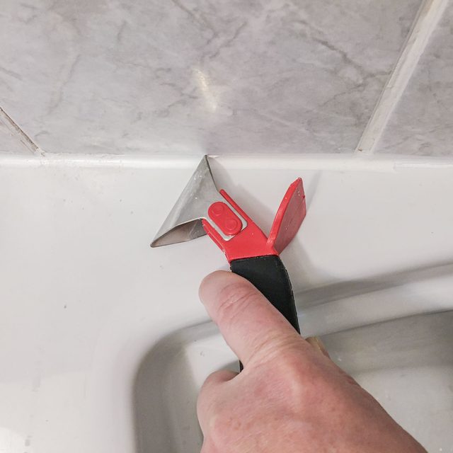 Remove old caulk with removal tool