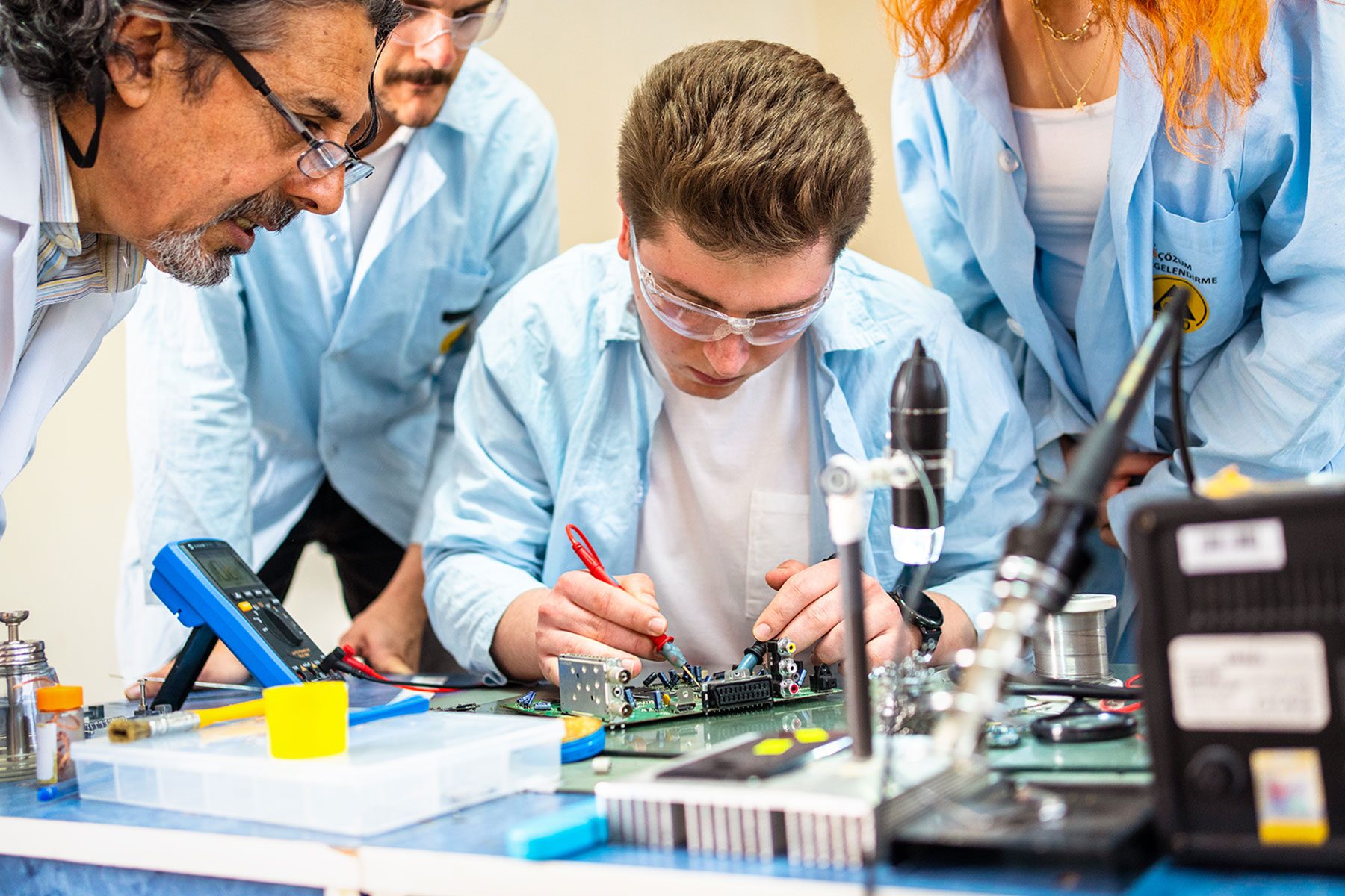 Group of young people in technical vocational training with teacher