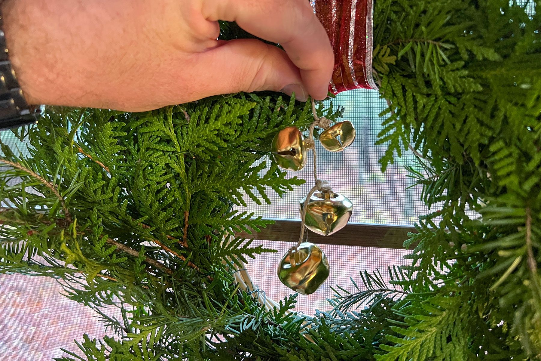 Putting bells on wreath