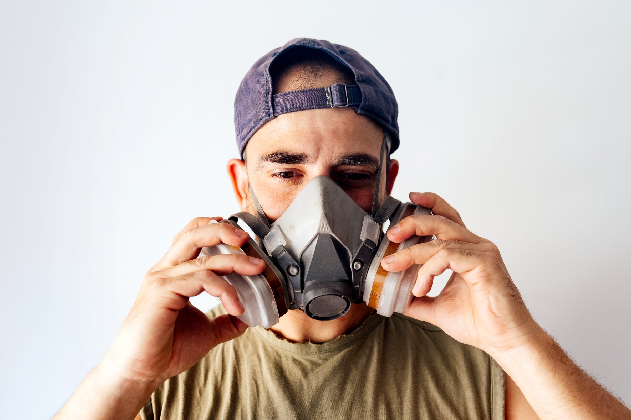 man putting on a Respirators for Paint