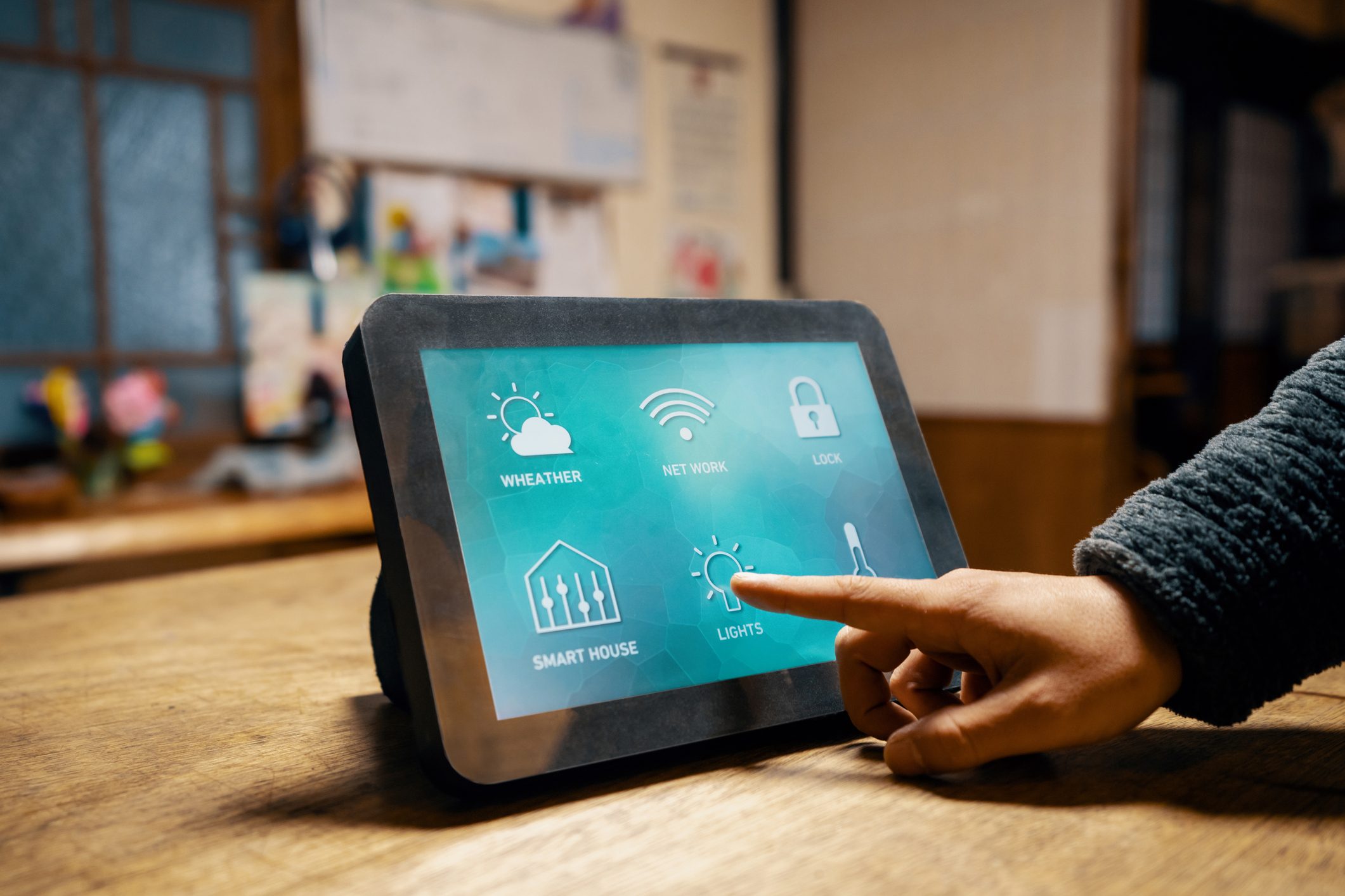 Mid adult man turns lights off or on with a smart device