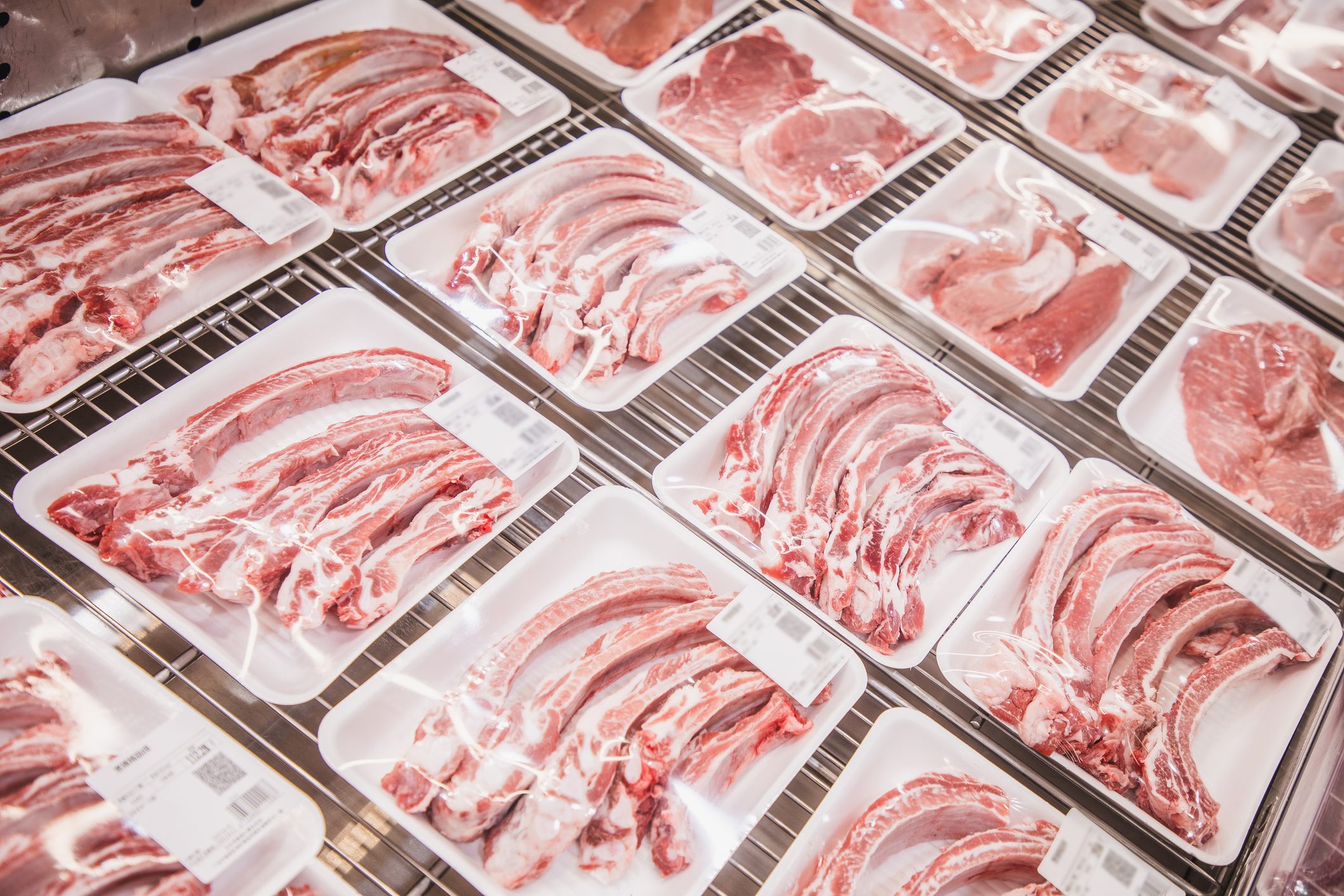 variety of tray packing meat on the supermarket freezer