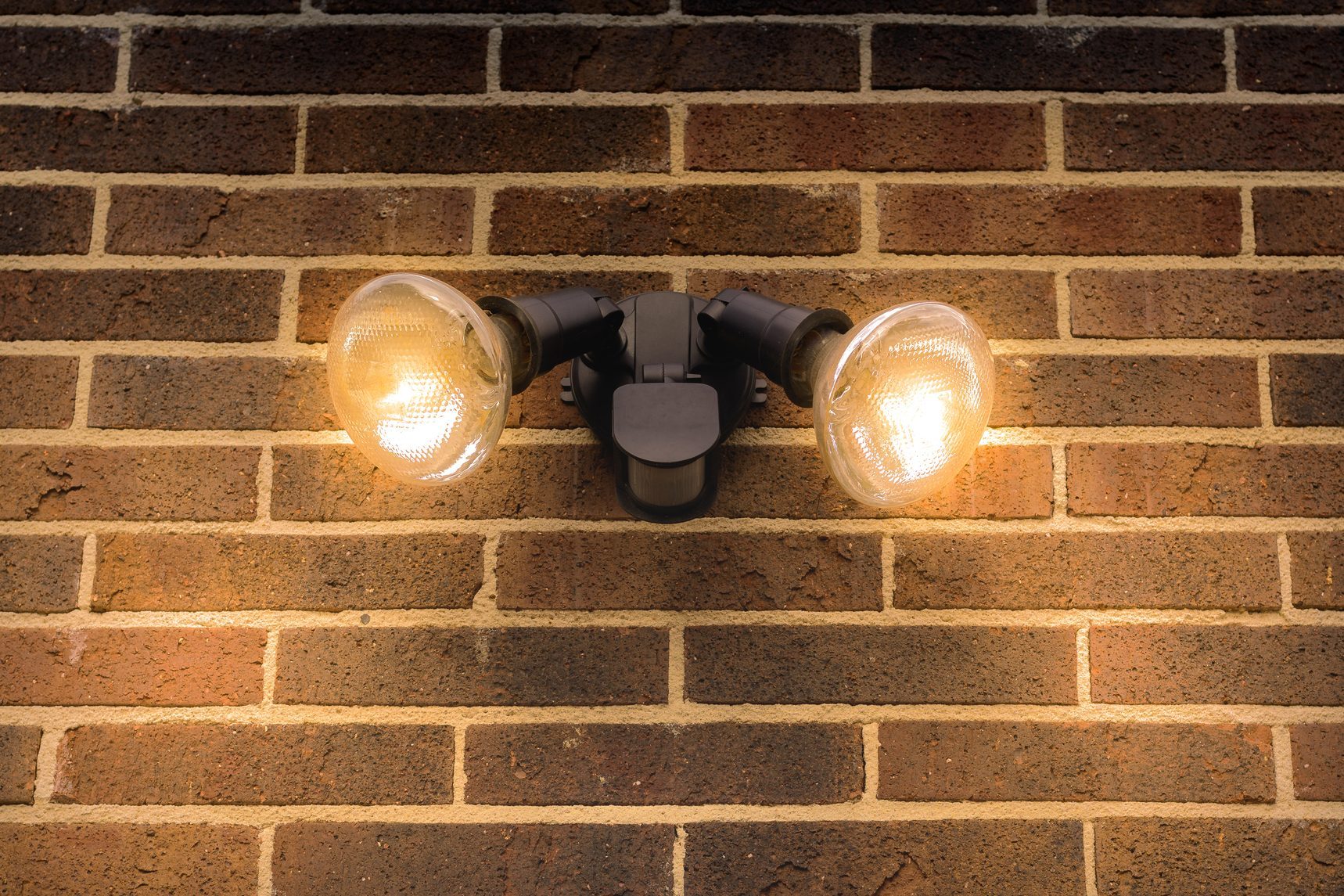 Flood light on external brick wall daytime look up