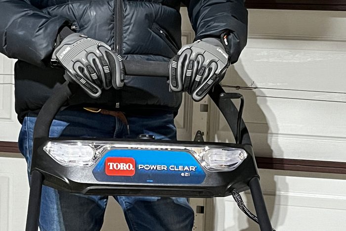 Holding snow blower while wearing gloves
